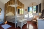Canopy double bed in this spacious room with views
